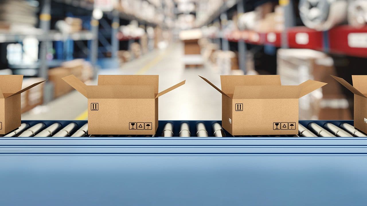 Cardboard boxes on conveyor rollers inside a warehouse ready to be shipped by courier for distribution | Image Credit:  ©alphaspirit - stock.adobe.com