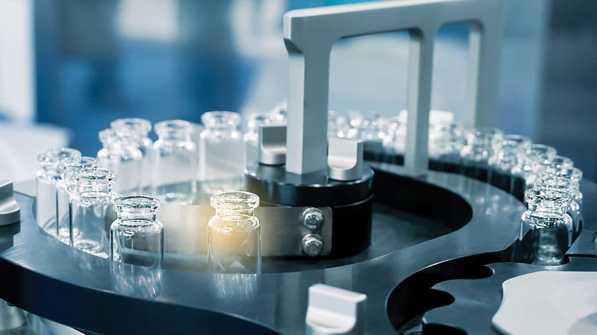 Pharmacological production. Aseptic vaccine vials in the production line. Sterile capsules for injection Bottles on the bottling line of the pharmaceutical plant. | Image Credit: © surasak – stock.adobe.com